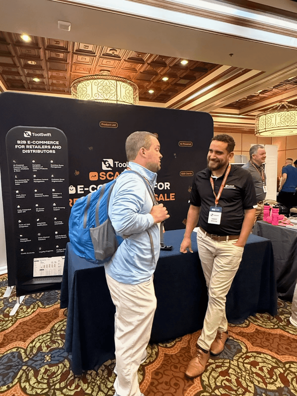 Hany Ibrahim at the ToolSwift booth talking with an attendee at a software and buying group show
